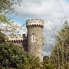 Garden wall with gateways and folly tower attached to west and east of Caerhays castle