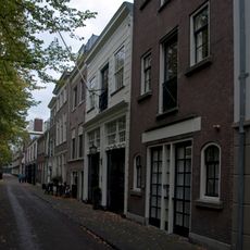 Koetshuis met pilasterstelling om de deuromlijsting gesneden kalf