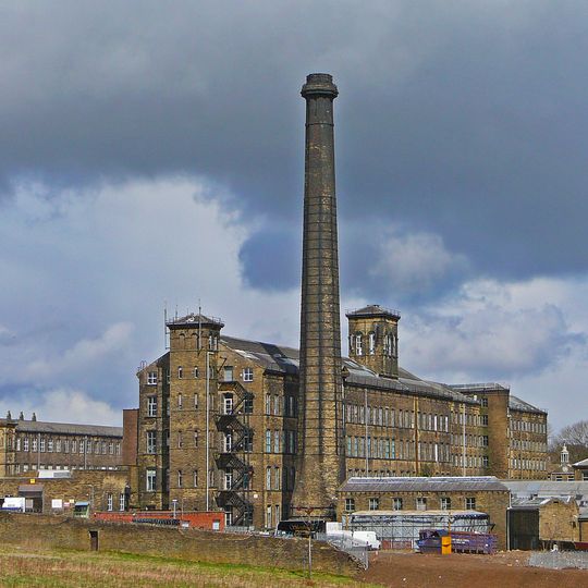 Mill chimney approximately 3 metres to south of principal mill buildings at black Dyke Mills