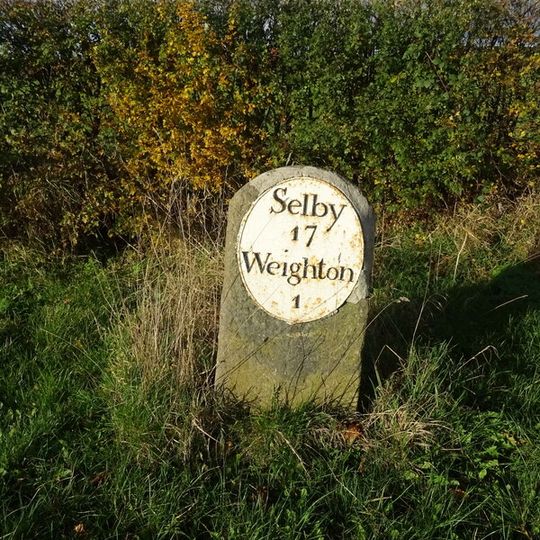 Milestone, opp. Mile House Farm