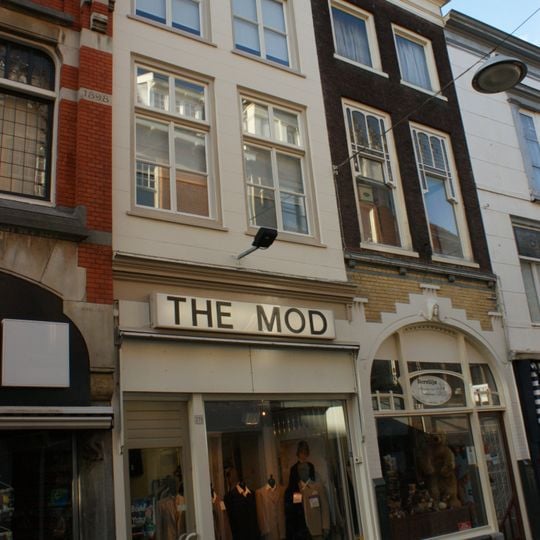 Pand met aan de wijnhaven afgeknotte trapgevel met ontlastingsbogen en oude kozijnen