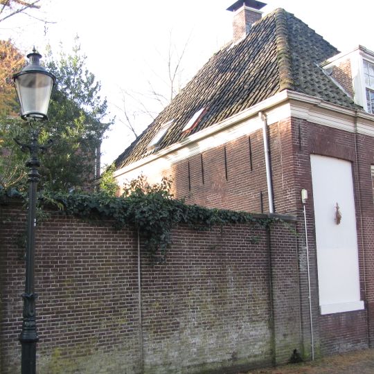 Woonhuis en schoolgebouw bij de synagoge. Voor- en zijgevel in baksteen uitgevoerd in spaarnissen. Maakt deel uit van het synagoge-complex