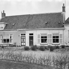 Huis met zadeldak, gepleisterde langsgevel aan de Ring. Vensters en deur vernieuwd
