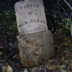 Milestone, 100m W of mini-roundabout