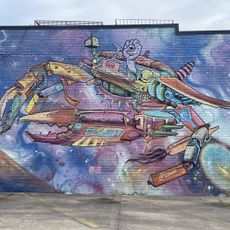 A painting of a gigantic mechanized crab built of various devices and objects
