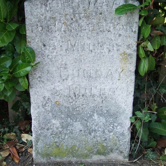Milestone, High Road, by No. 25, opp. The Bell PH