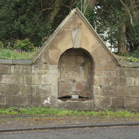 Pant And Adjacent Walls 30 Metres South West Of Road Junction In Centre Of Village
