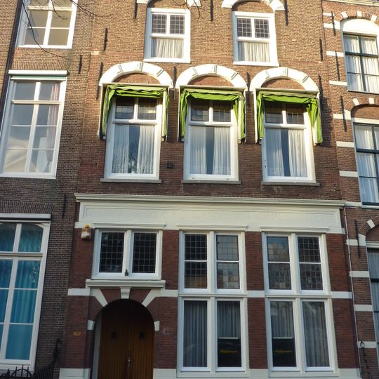 Pand met bakstenen gevel met rechte kroonlijst, zandstenen togen boven de vensters 1e en 2e verdieping. onderpui vernieuwd