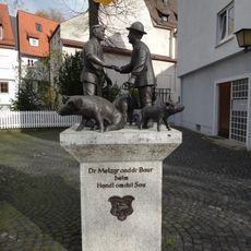 Bauer und Metzger beim Schweinhandel