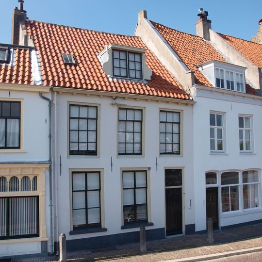Huis met gepleisterde lijstgevel met oude scheidsmuur