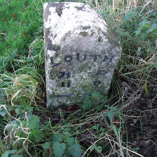 Milestone In Village Centre On South Side Of Road