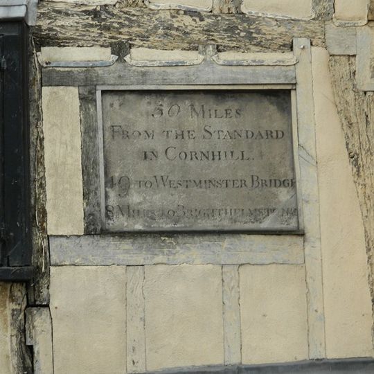 Milestone, High Street, No. 99/100 ; in wall of timber framed house, now a bookshop
