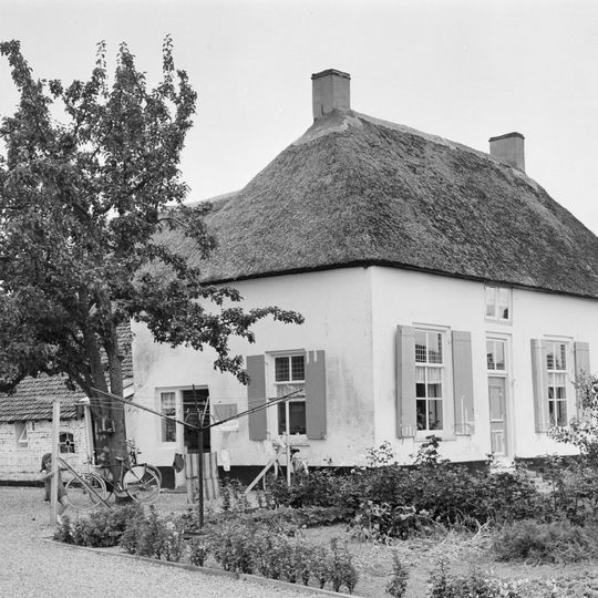 Gepleisterde boerderij, woonhuis en stal vormen een T-vormige plattegrond