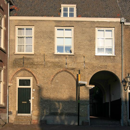 Woonhuis tegen de noordgevel van de Augustijnenkerk in de hoek tussen het schip dezer kerk en de kloostergang. Lijstgevel, late Empire ramen en schilddak.
