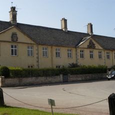 The Almshouse And Former School And Boundary Walls And Gate Piers To The Road