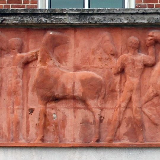 Riders at the horse trough