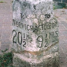 Milestone, 5yds E of Griston Rd in front of office/shop