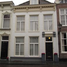 Huis onder schilddak en met gesausde lijstgevel