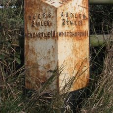Milepost, W of entrance to The Grange