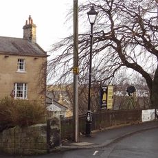 Wall And Railings Enclosing Lawn In Front Of Sun Hotel