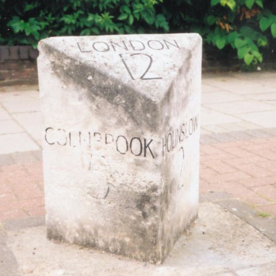 Milestone, Bath Road; centre of Cranford, 50m E of crossroads/traffic lights; E of subway to The Avenue