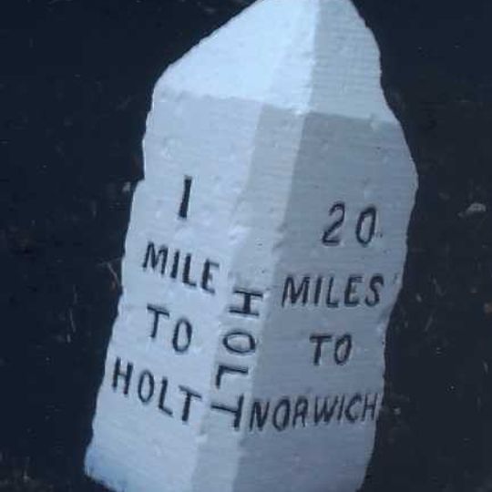 Milestone, 60yds N of FP style, c.1/2mile S of Holt Country Park entrance