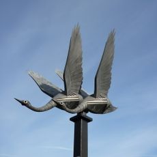 Swans in flight sculpture