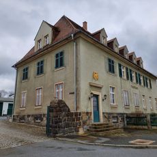 Post mit Einfriedung, Toreinfahrt sowie Adlerrelief, Ecklampe „Postamt“ und Fassadenschriftzug Poststraße 1