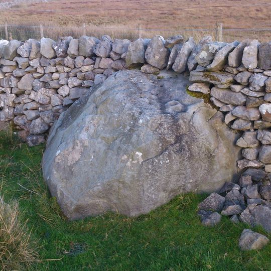 Rock with 30 to 40 cup marks and some groove marks in the wall at the west side of Black Hill Road, 610m ESE of New Dam, Skyreho