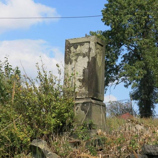 Podstavec s ulomeným křížem v centru Mukařova