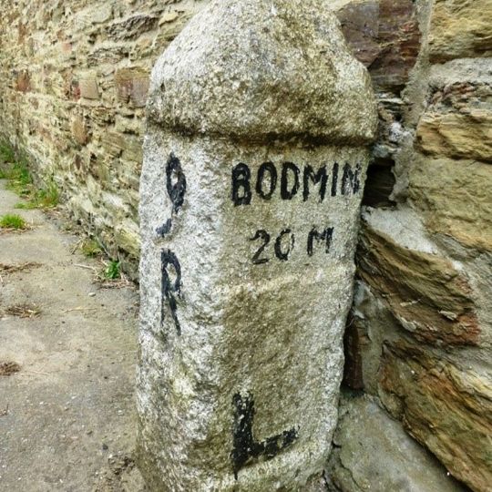 Milestone On High Road Against Wall Of Zelah Lane Chapel