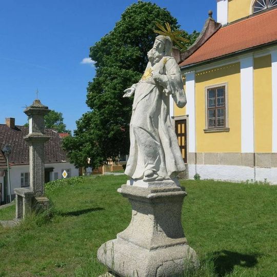 Socha světce vlevo na terase kostela Nanebevzetí v Chlumu u Třeboně