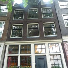 Pand met zeer gave halsgevel met gedeelde vleugelstukken, houten pui met deur