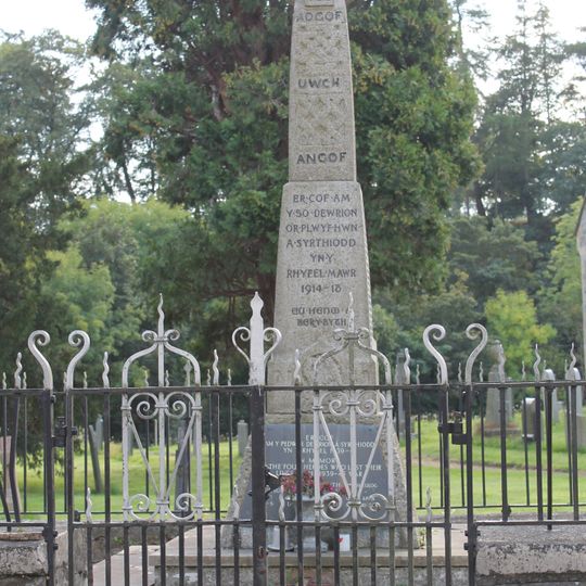 Parish War Memorial at St Dogfan's Church with surrounding railed enclosure.