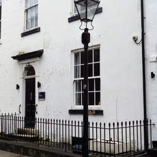 Gas Lamp Post On Pavement Between Numbers 10 And 11