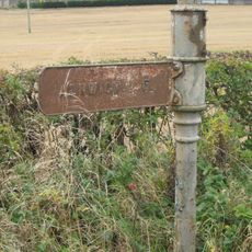 Guide Post On South Of Road Junction 300 Metres West Of Battle Bridge