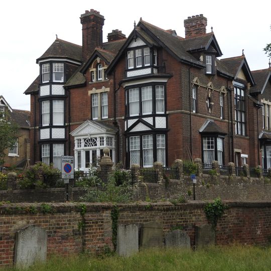 Wall With Gates Enclosing Churchyard Of St Margaret's Parish Church With Headstones Attached