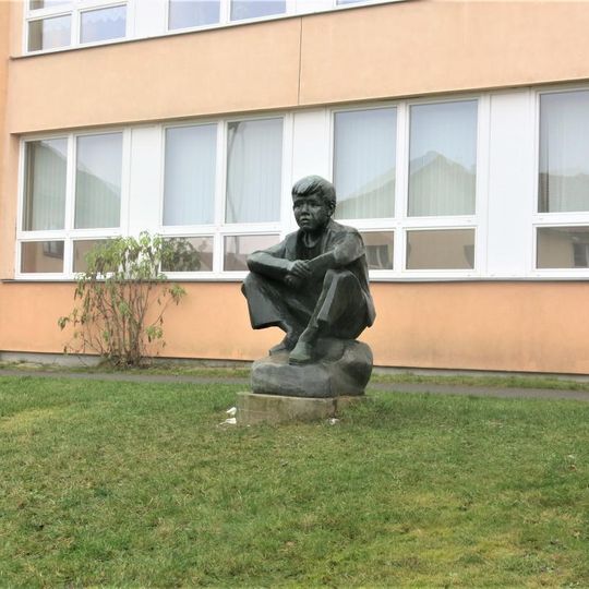 Socha Sedící chlapec u školy v Okružní ulici v Rakovníku