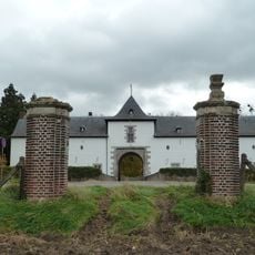 Two pillars crowned with vases at Geulle Castle