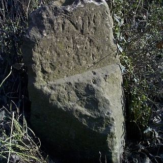 Milestone On East Verge Of Road And Adjoining The Garden Of Numbers 33 And 35