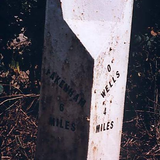 Milepost, 20yds S of double electricity pole whose wires cross road