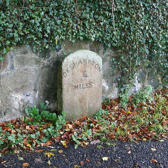 Milestone, by drive of Trafalgar House, S end of Sticklepath