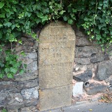 Milestone, Sidbury, Cotford Road, 50m N of school entrance; opp. Bowine Cottage,