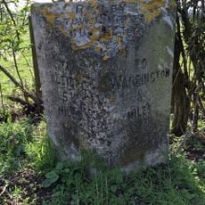 Milestone, Warrington Road, Risley; opp.  Rowe Farm against hedgerow