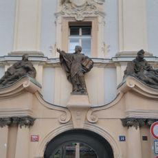 Sochy nad portálem bývalé jezuitské koleje na Karlově náměstí