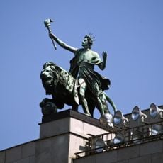 Lion and genius on Česká národní banka building in Prague