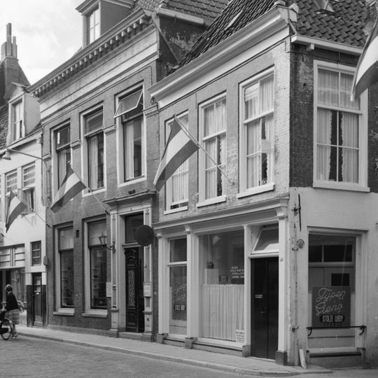 Pand met eenvoudige rechte kroonlijst onder diep zadeldak met voorschild