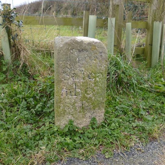 Milestone, Salcombe Road, West Batson, 300m NW of turn to Motherhill Farm, by entrance gate for new cycle track