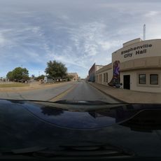 A mural of a cowboy boot with the state of Texas painted in a state flag style. The initials JS are present for the founder of Stephenville.