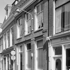 Eenvoudig pand met geblokte kroonlijst onder dwarskap